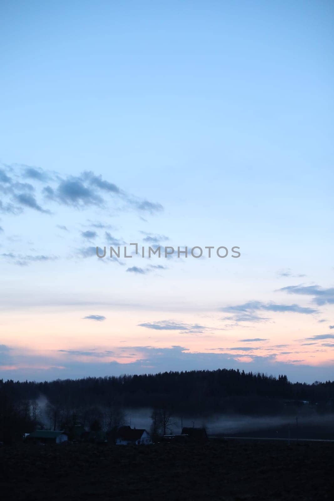 Glorious sunset over grassy rural landscape