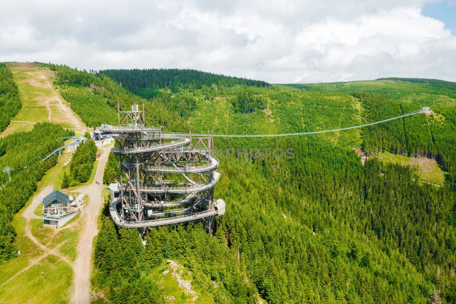 Aerial view of the worlds longest 721 meter suspension footbridge Sky bridge and observation tower the Sky walk in the forest, between mountains, Dolni Morava Ski Resort, Czech Republic.