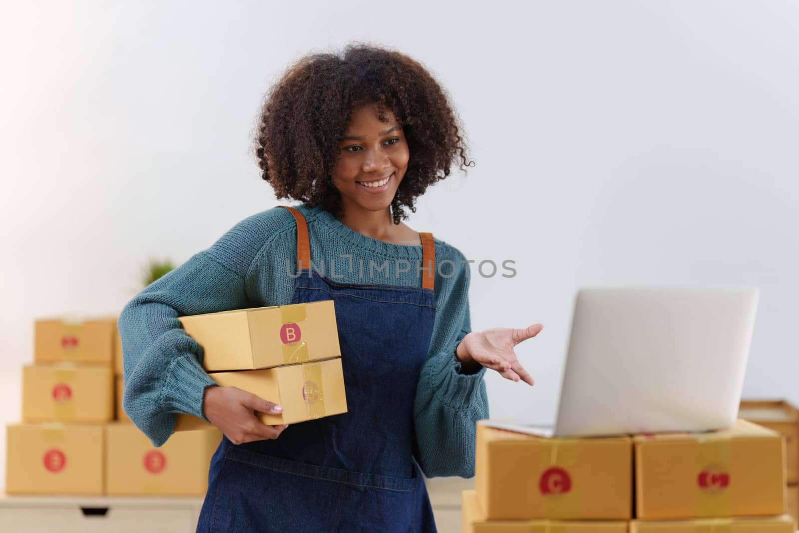 American African entrepreneur smile and checking online order. Successful SME entrepreneur concept by itchaznong