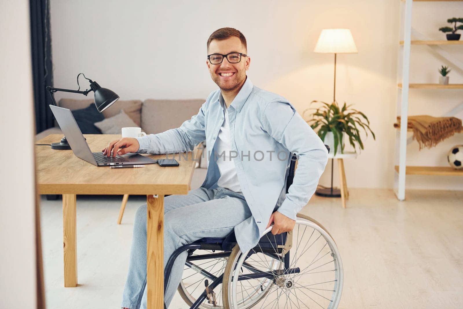 Working on a project from home. Disabled man in wheelchair.