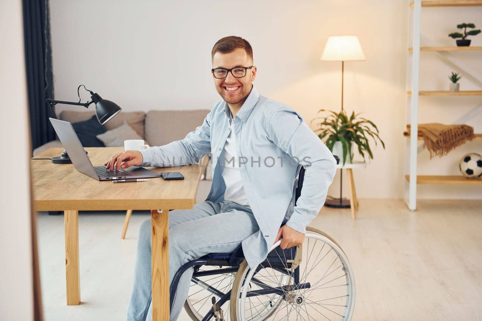 Working on a project from home. Disabled man in wheelchair.