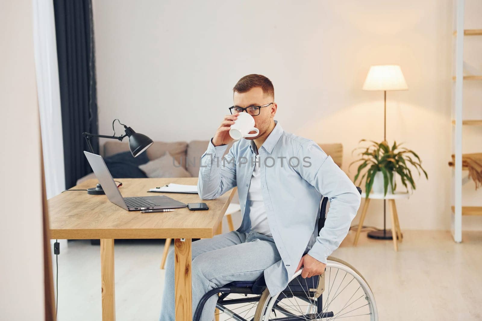 Working on a project from home. Disabled man in wheelchair.