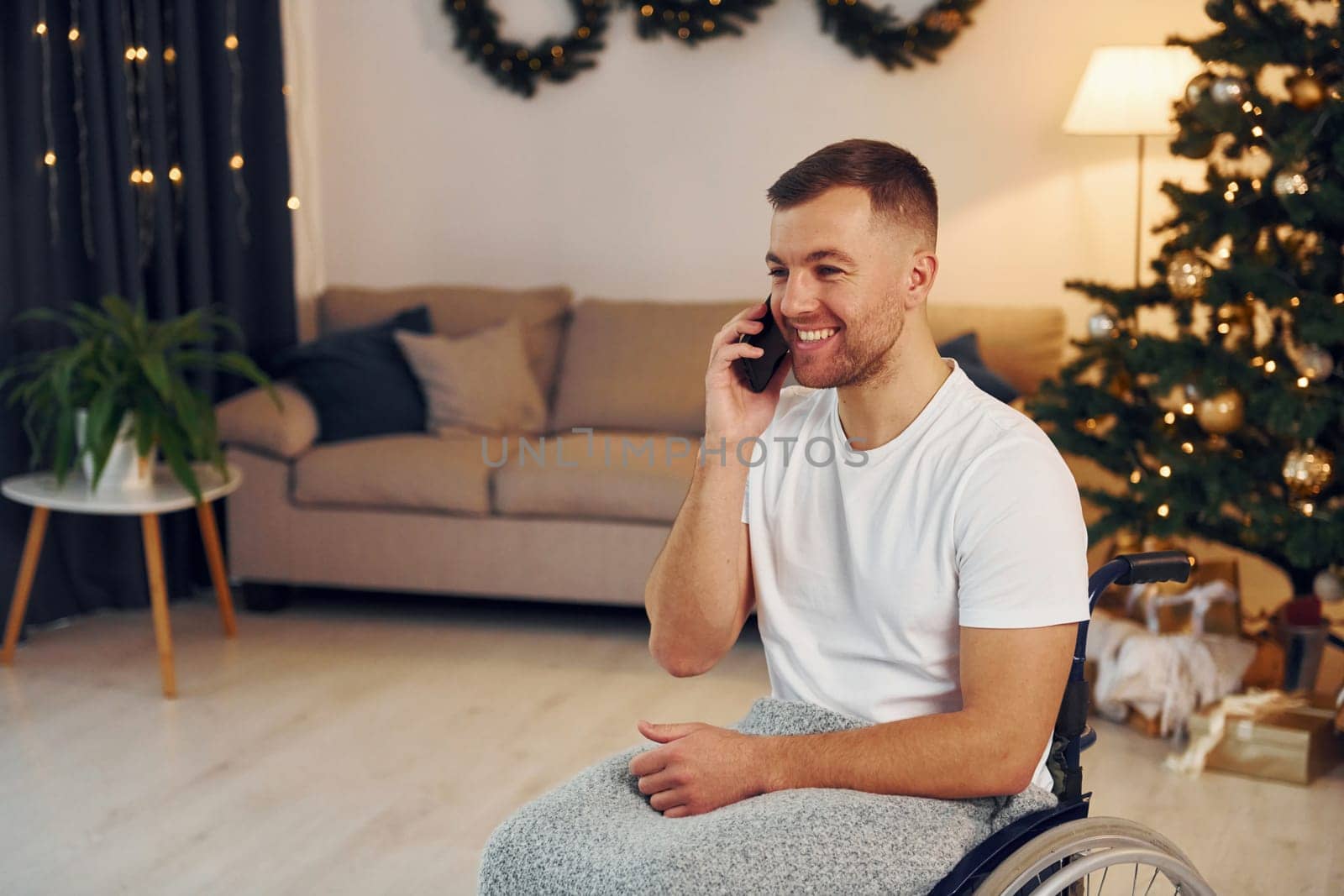 New year is coming. Disabled man in wheelchair is at home.