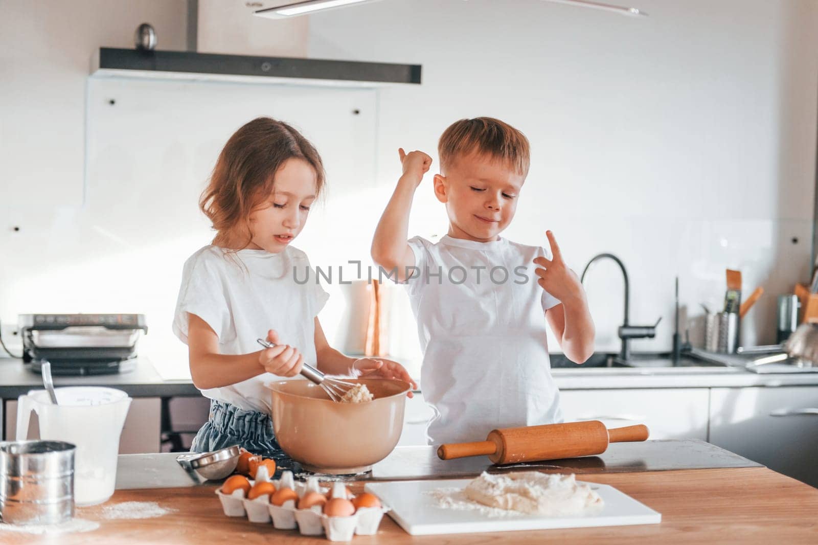 Preparing Christmas cookies. Little boy and girl on the kitchen.