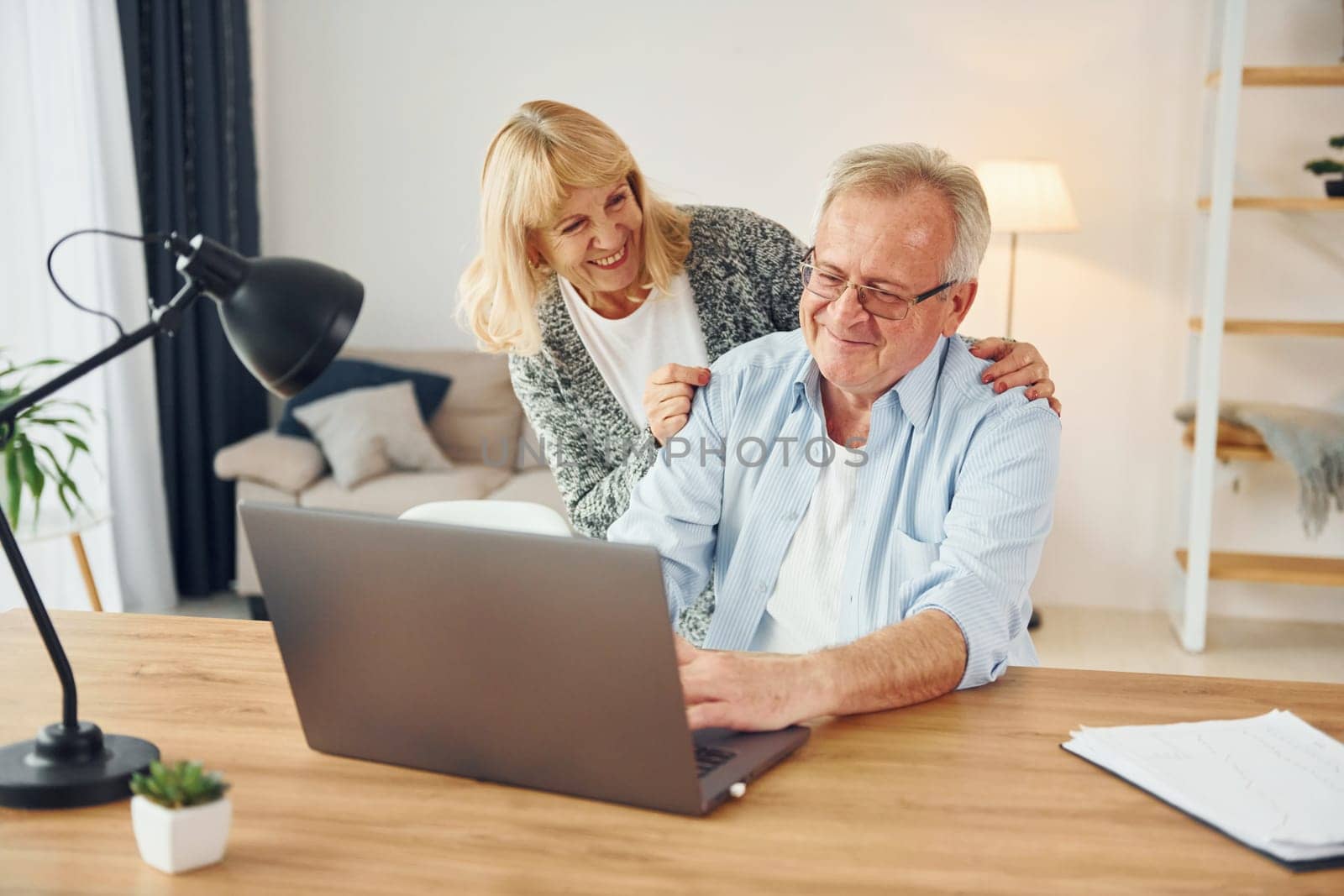 Using laptop. Senior man and woman is together at home.