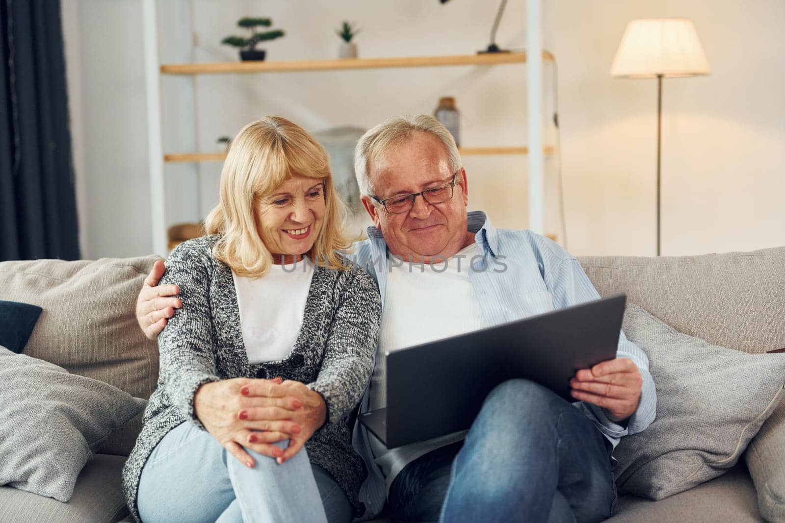 Internet connection. Using laptop. Senior man and woman is together at home.