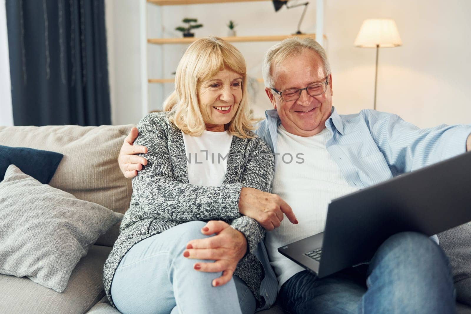 Internet connection. Using laptop. Senior man and woman is together at home by Standret