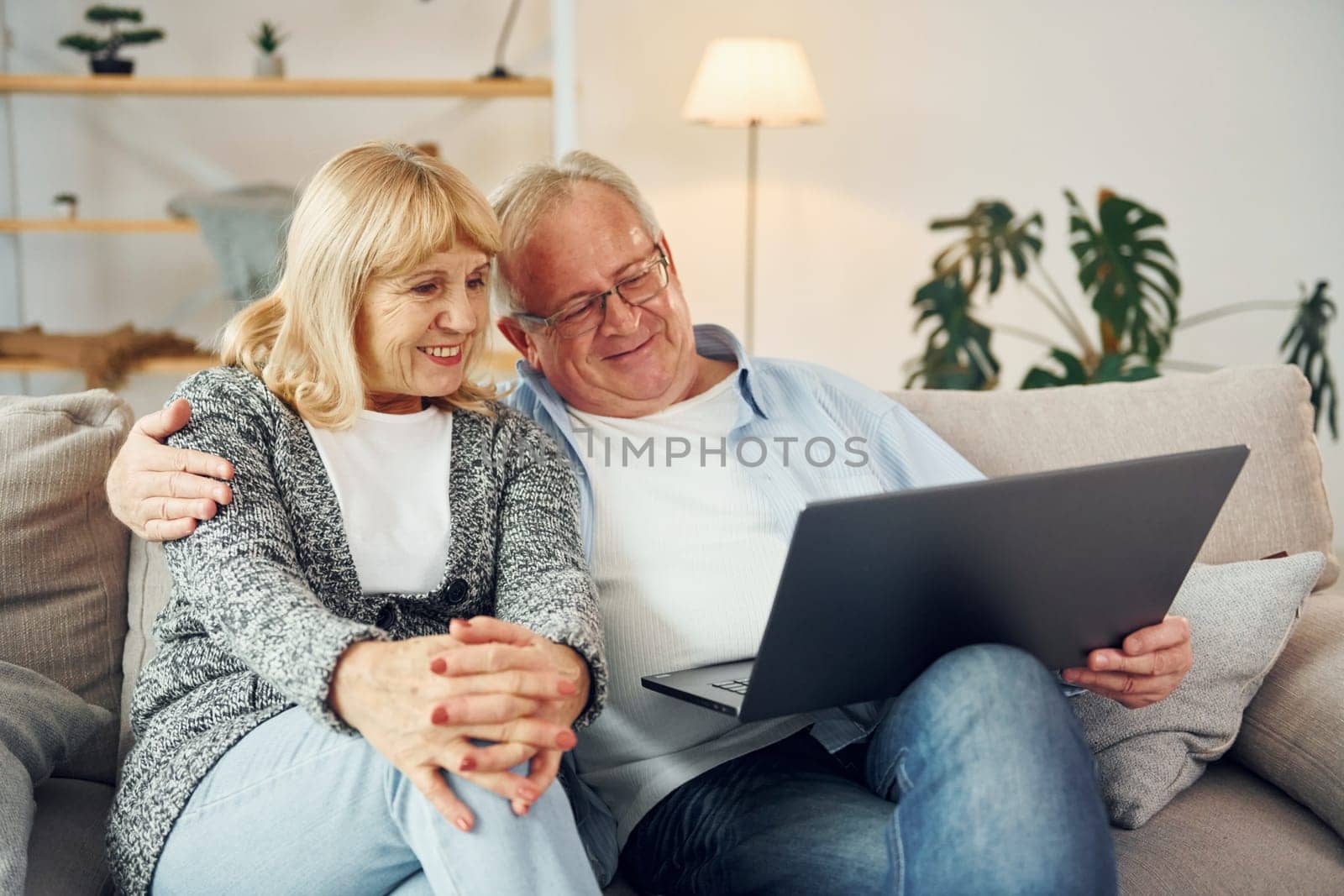 Internet connection. Using laptop. Senior man and woman is together at home.