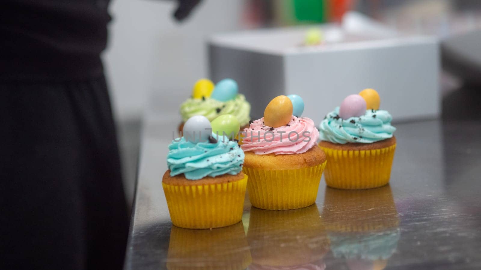 easter pastel handmade group of muffins with confetti chocolate eggs on top