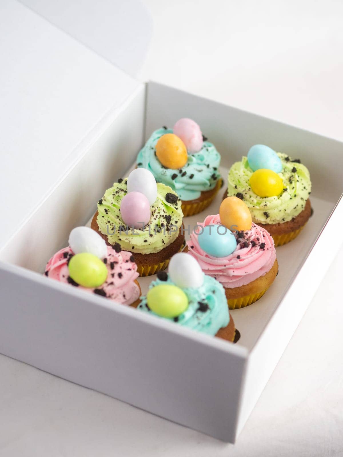 easter pastel handmade group of muffins with confetti chocolate eggs on top