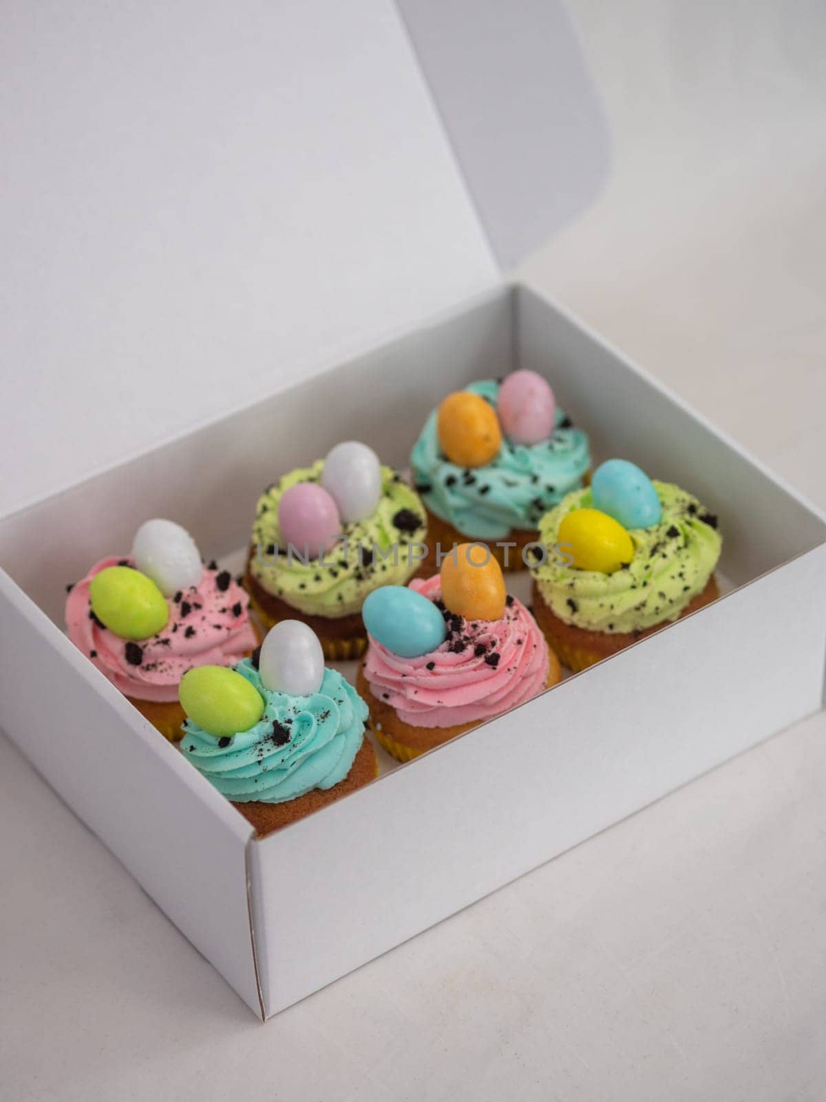 easter pastel handmade group of muffins with confetti chocolate eggs on top