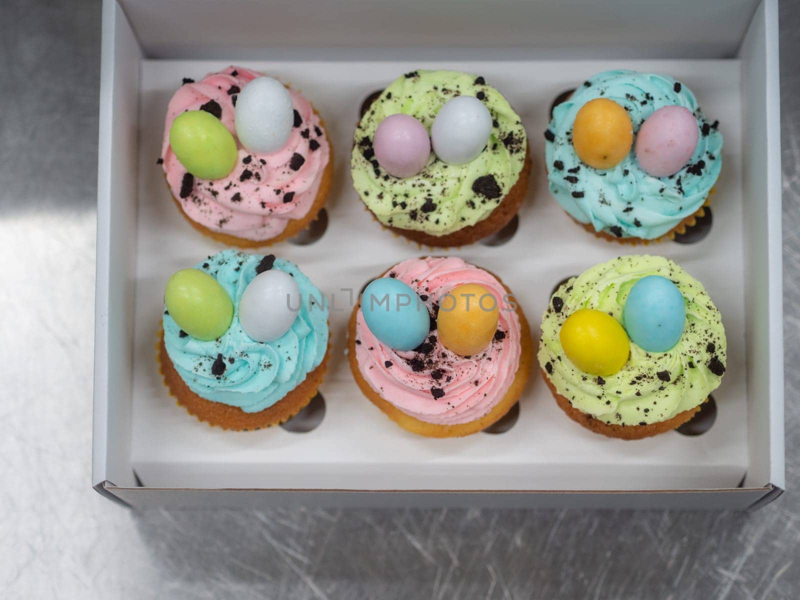 easter pastel handmade group of muffins with confetti chocolate eggs on top