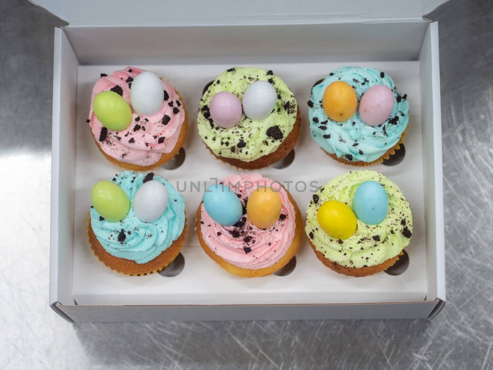 easter pastel handmade group of muffins with confetti chocolate eggs on top