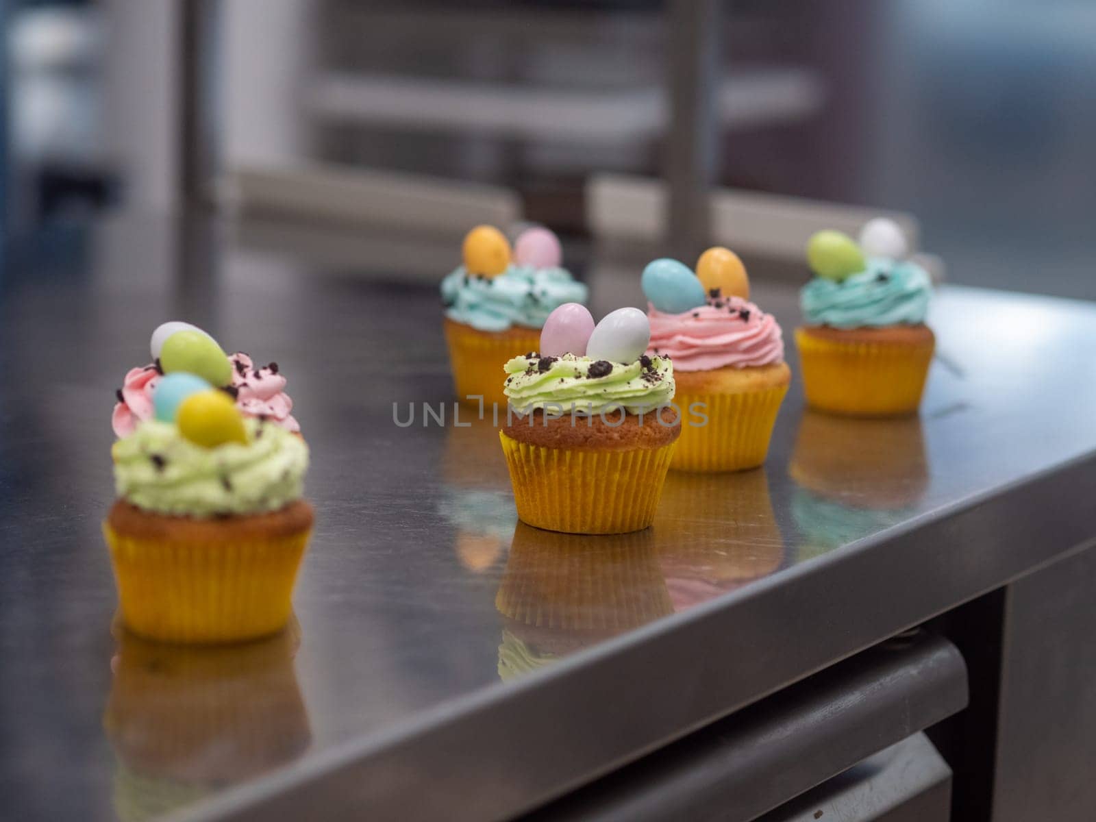 easter pastel handmade group of muffins with confetti chocolate eggs on top