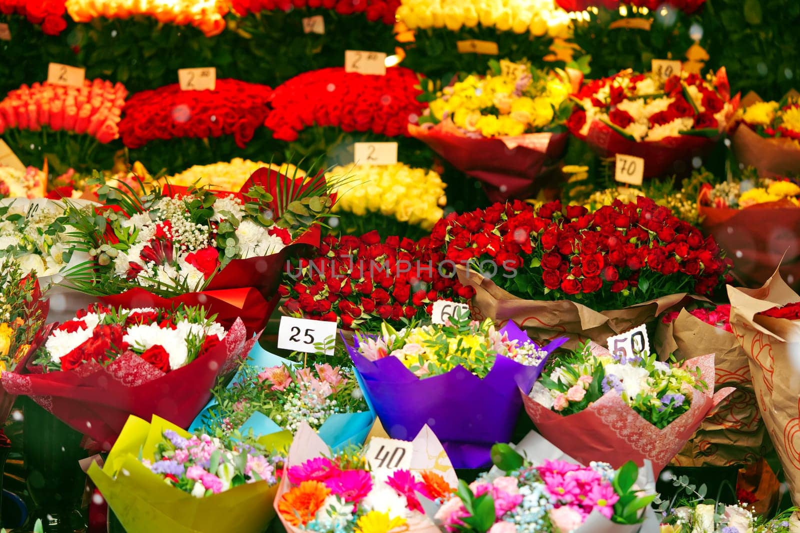 Colorful roses bouquet display in front of flower shop. Flower arrangements for sale at local market. Flowers on sale before mother day, 8 march.
