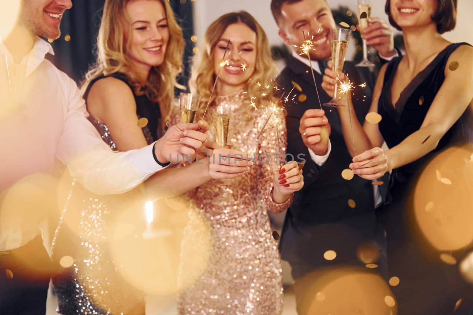 Celebration of new year. Group of people have a new year party indoors together by Standret