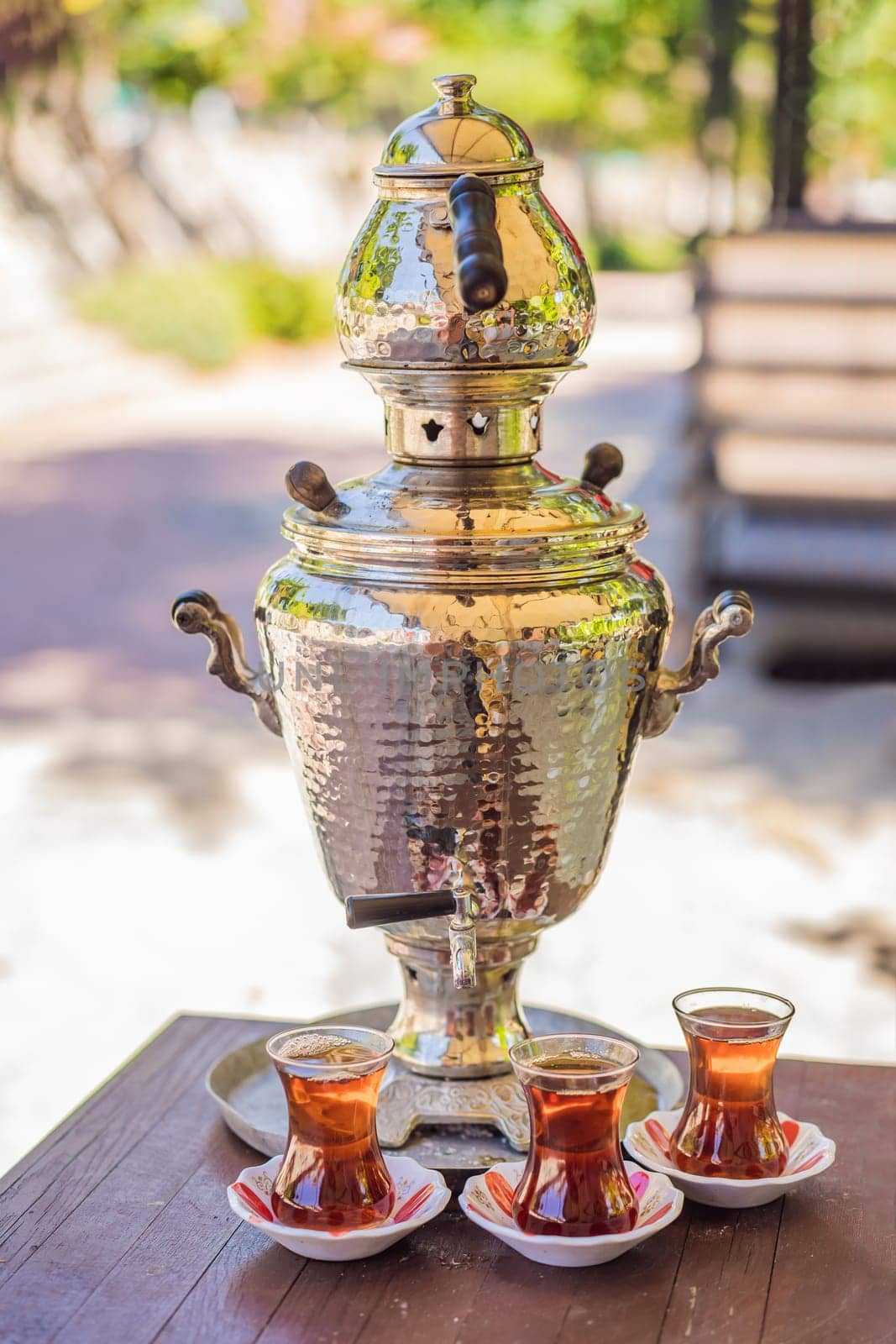 Drinking Traditional Turkish Tea with Turkish tea cup and copper tea pot by galitskaya