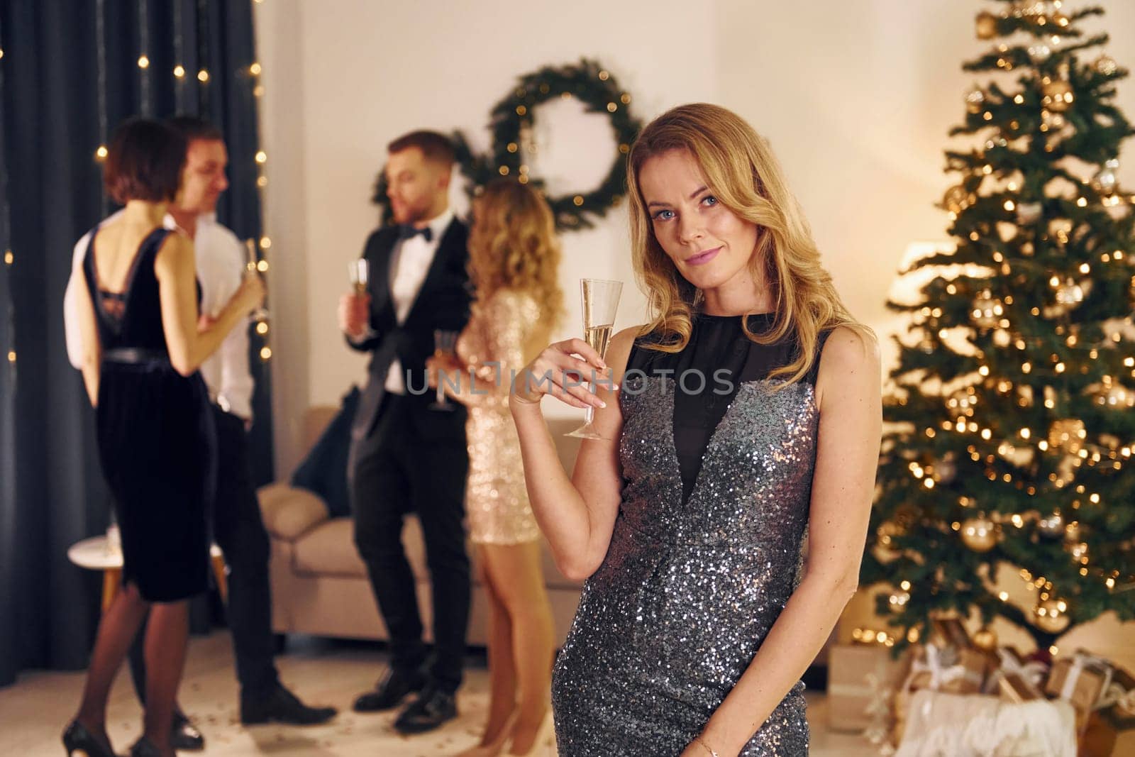 Conception of x-mas holidays. Group of people have a new year party indoors together.