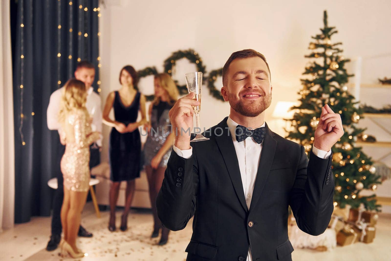 Conception of anticipation. Group of people have a new year party indoors together.