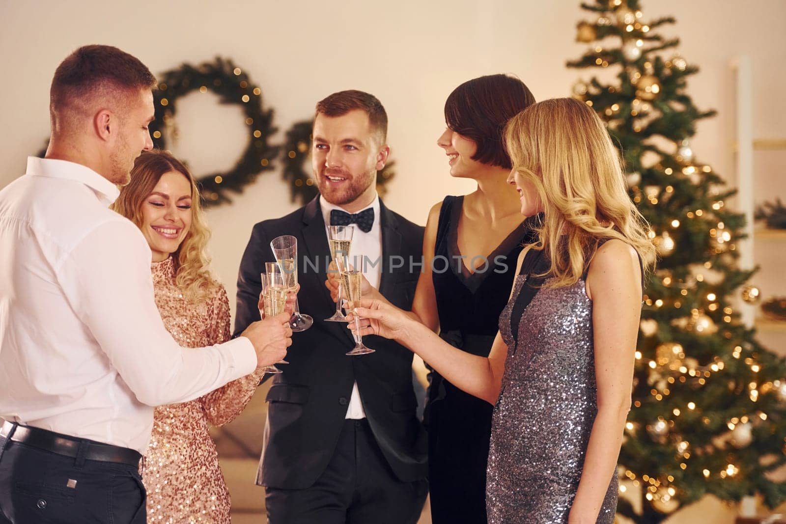 Sincere positive emotions. Group of people have a new year party indoors together.