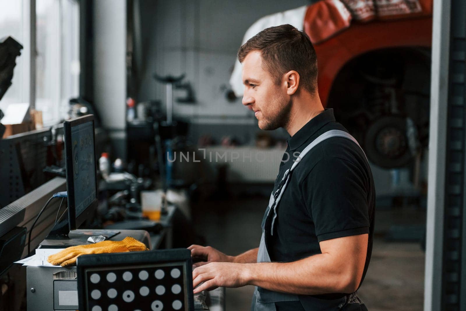 Work in progress. Man in uniform is in the auto service.