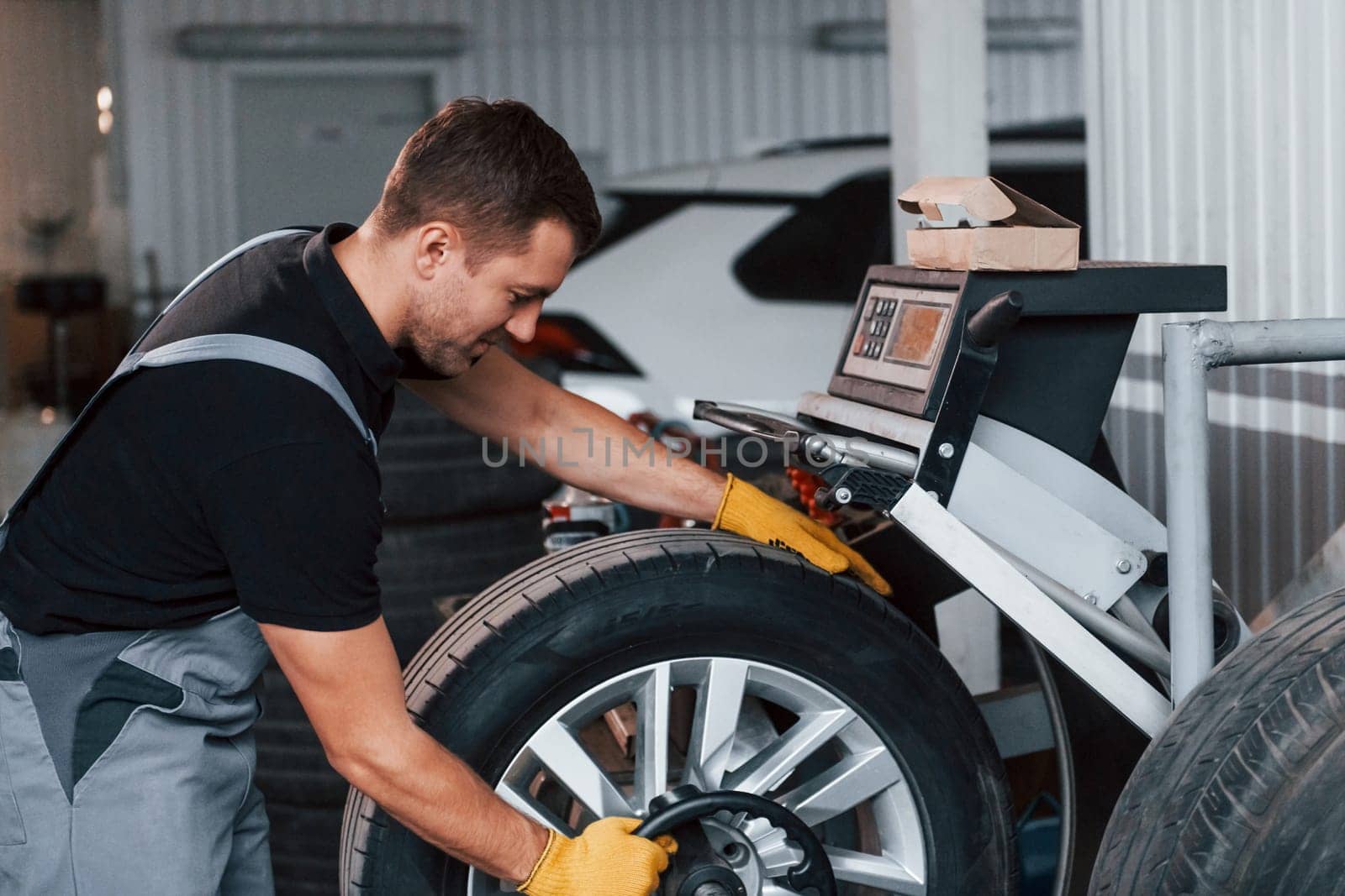 Work in progress. Man in uniform is in the auto service.