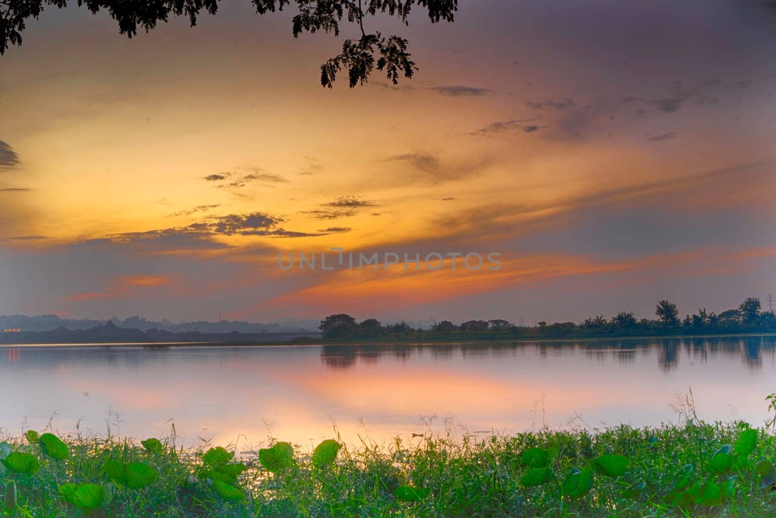 Beautiful view of Waduk Bunder or Water Dam Bunder in Gresik, East Java, Indonesia during sunrise and cloudy wheater.