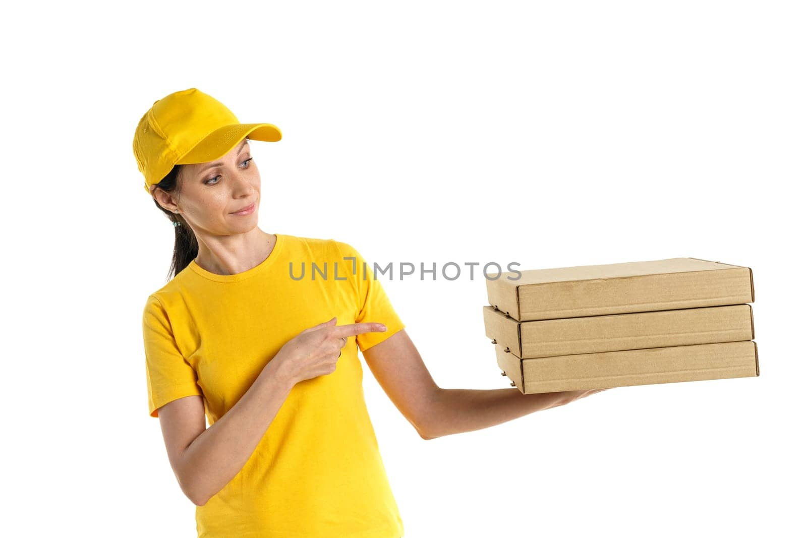 A pizza delivery woman of Caucasian appearance in a yellow uniform, holding cardboard boxes in her hands on a white background.