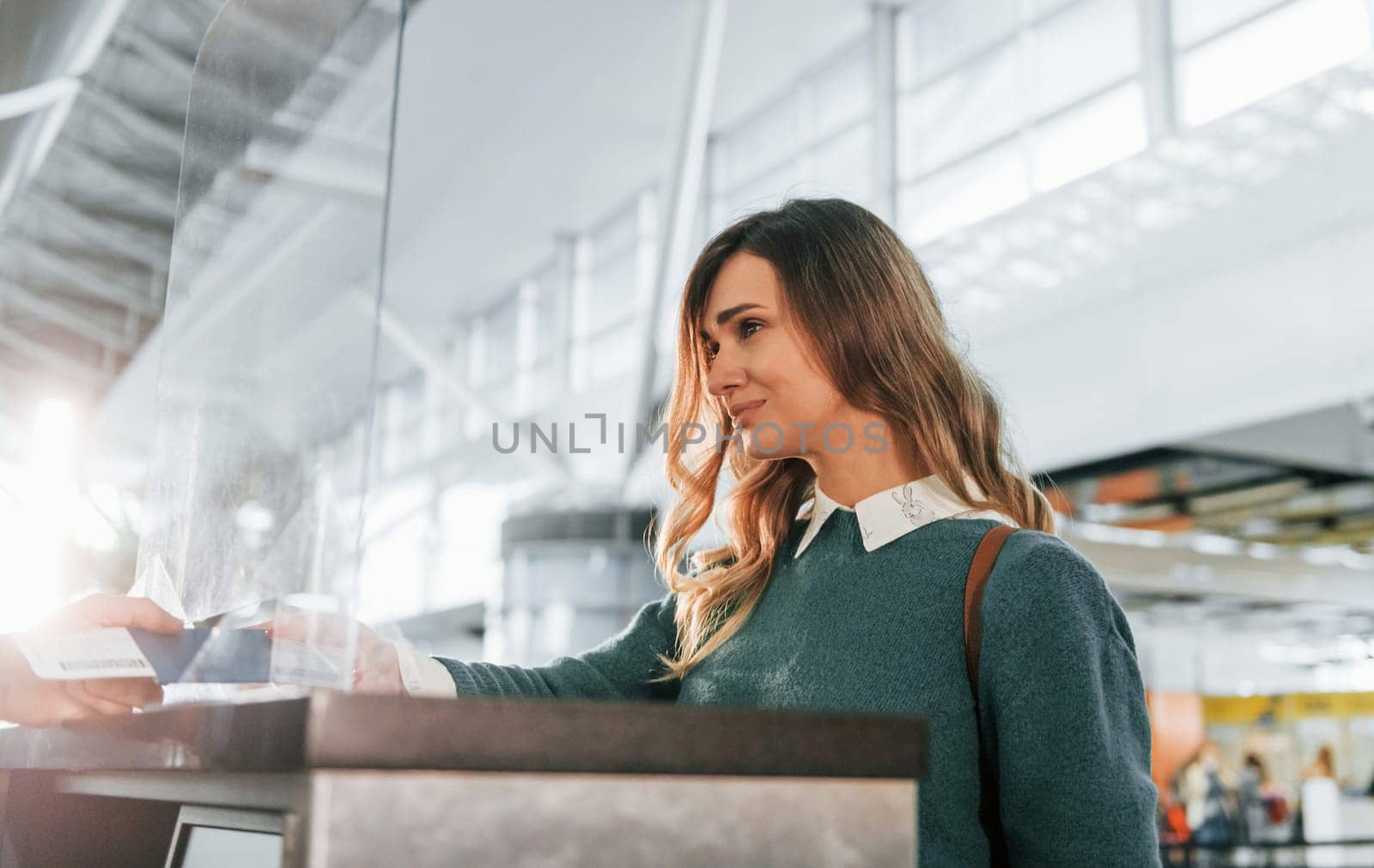 Beautiful lighting. Young female tourist is in the airport at daytime by Standret