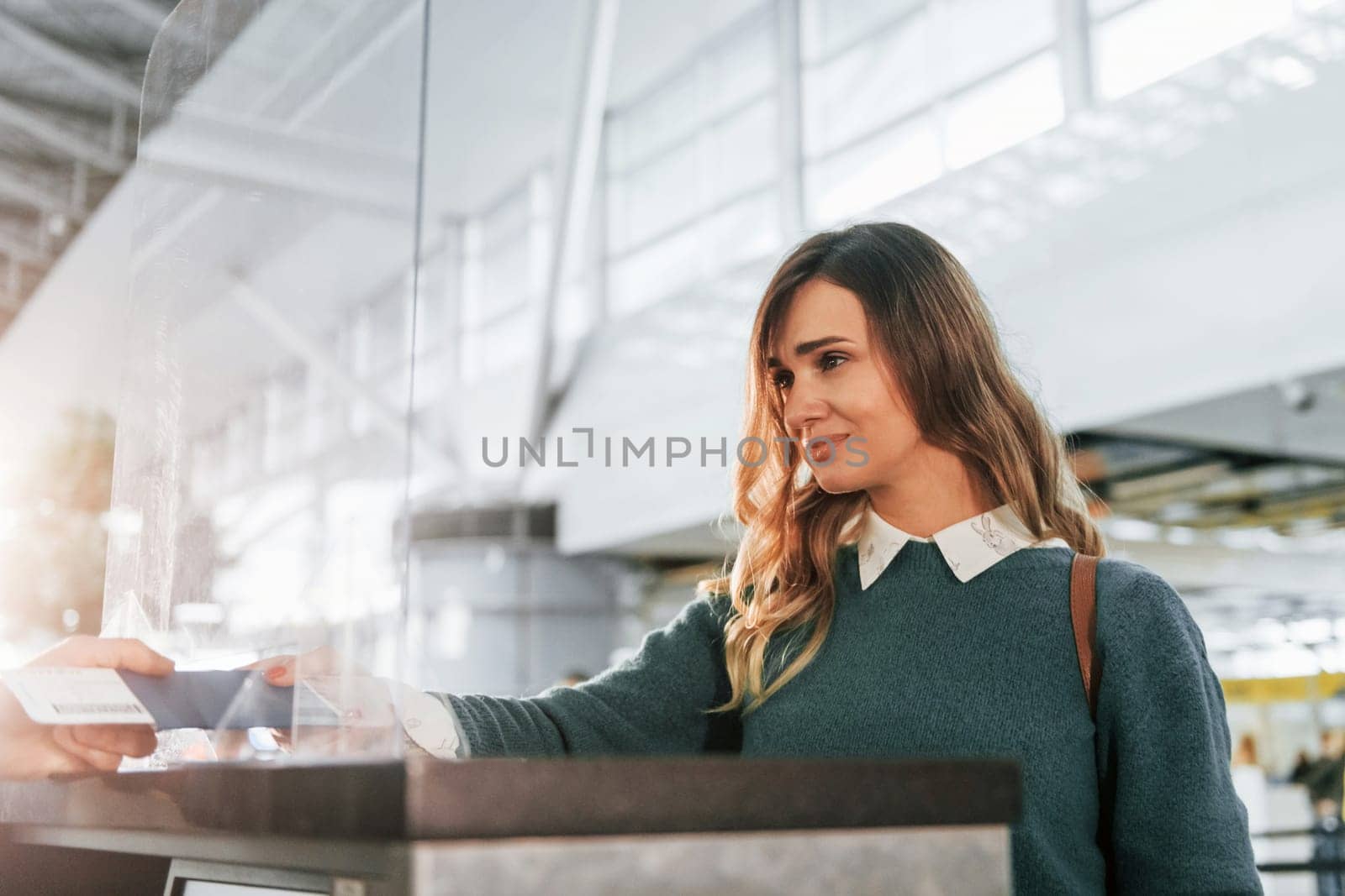 Beautiful lighting. Young female tourist is in the airport at daytime by Standret