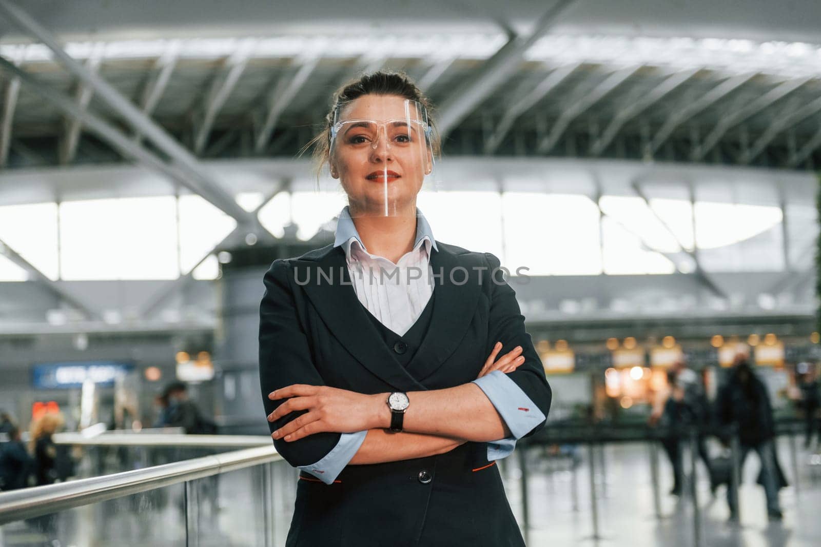 Woman in formal clothes is working in the airport as employee.