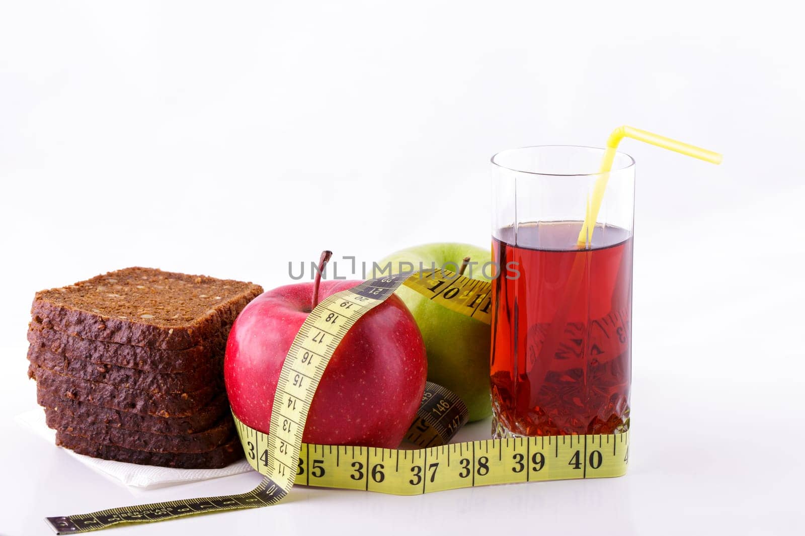 Rye bread apples and juice in glass on a white background with a measuring tape by EkaterinaPereslavtseva