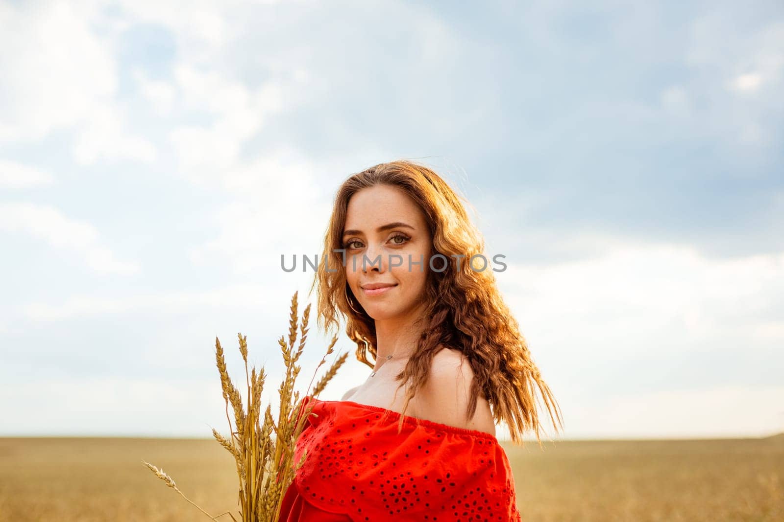 Young beautiful woman in golden wheat field. Happy woman by EkaterinaPereslavtseva