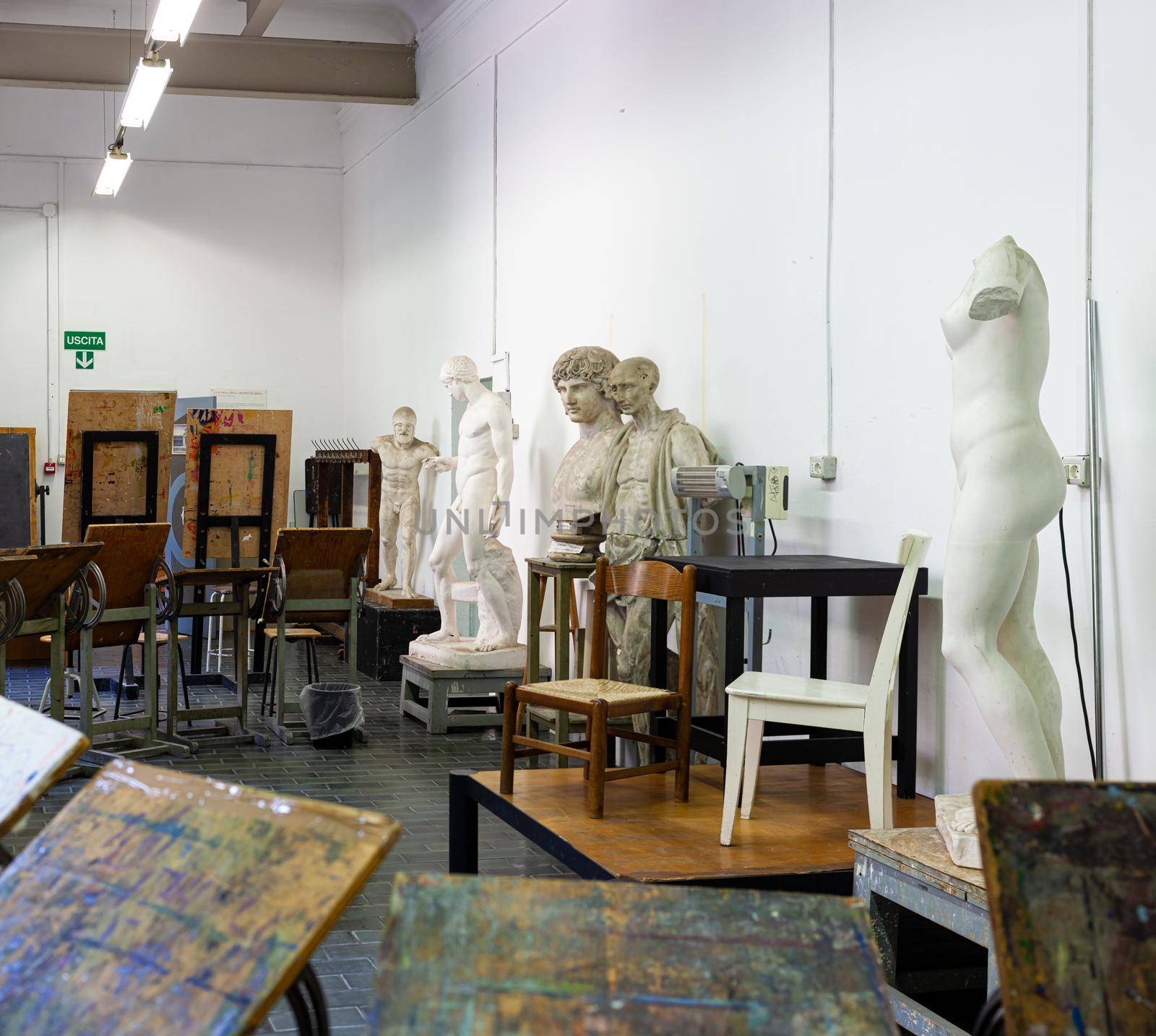 Easels, statues and chairs in the painting classroom of fine art school