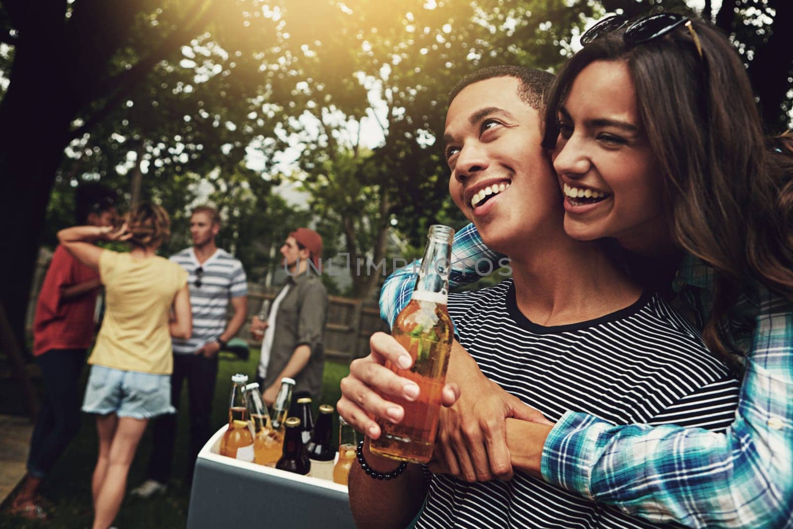 This is what summers all about. a young couple enjoying a party with friends outdoors