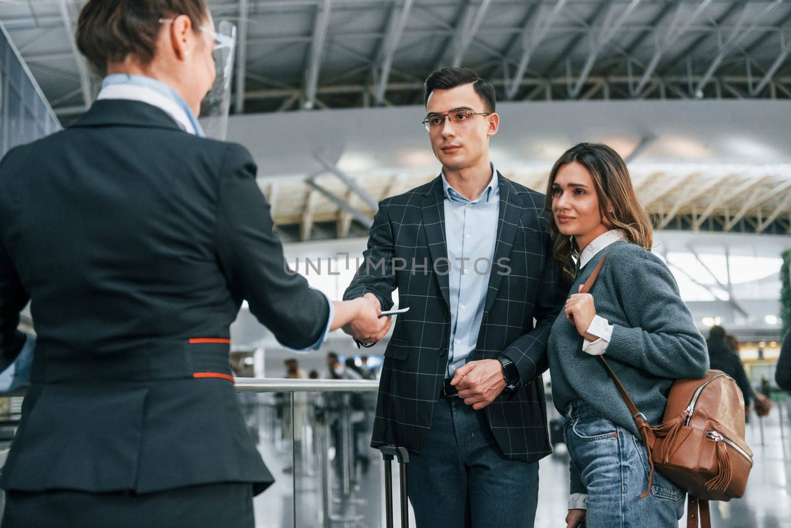 Passing procedure. Young couple is in the airport together.