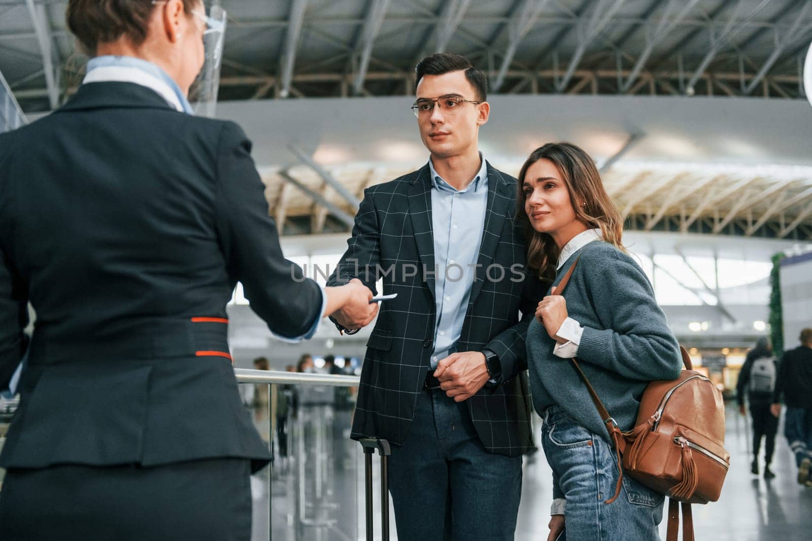 Passing procedure. Young couple is in the airport together.