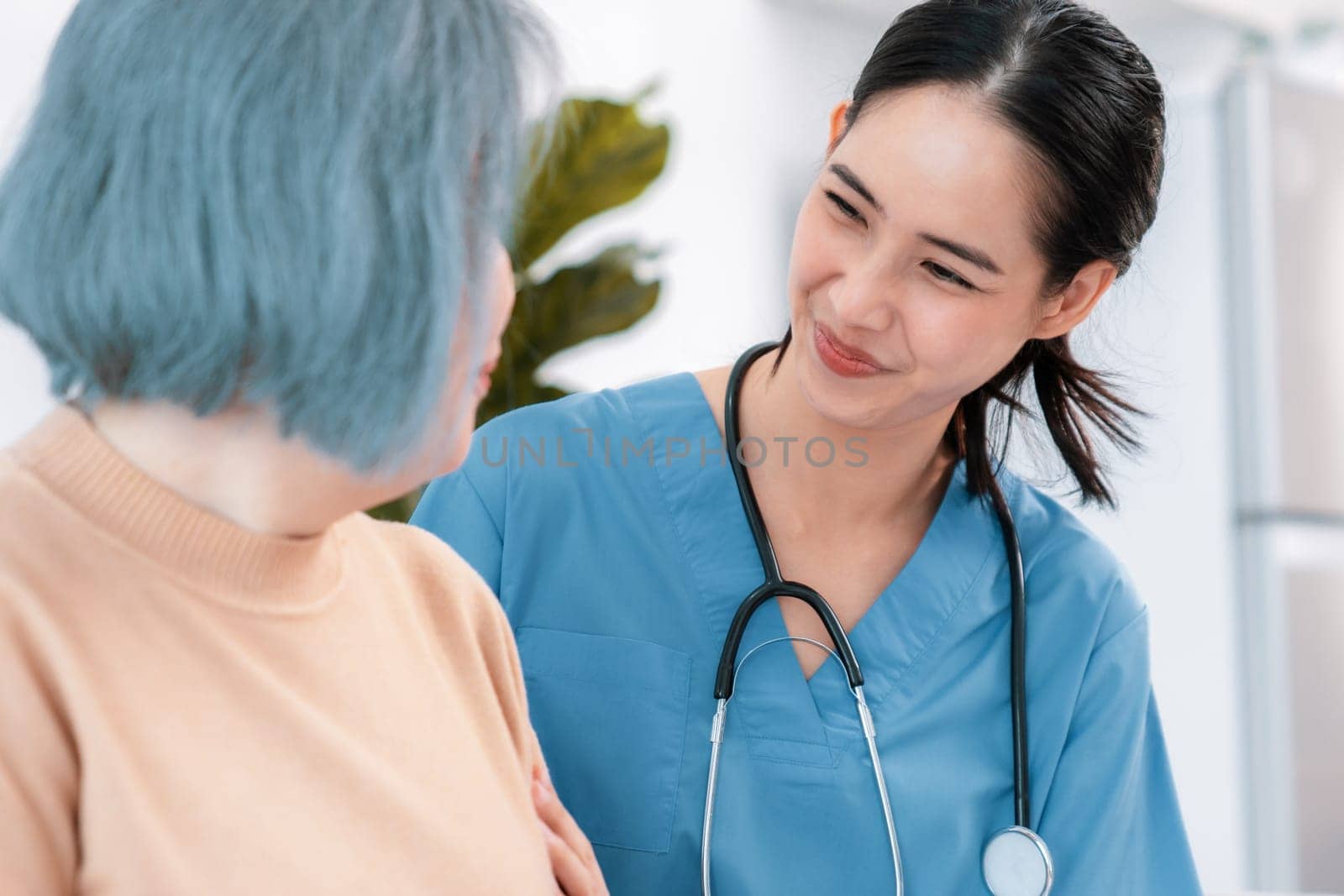 A caregiver rest her hands on the shoulders of a contented senior patient. by biancoblue