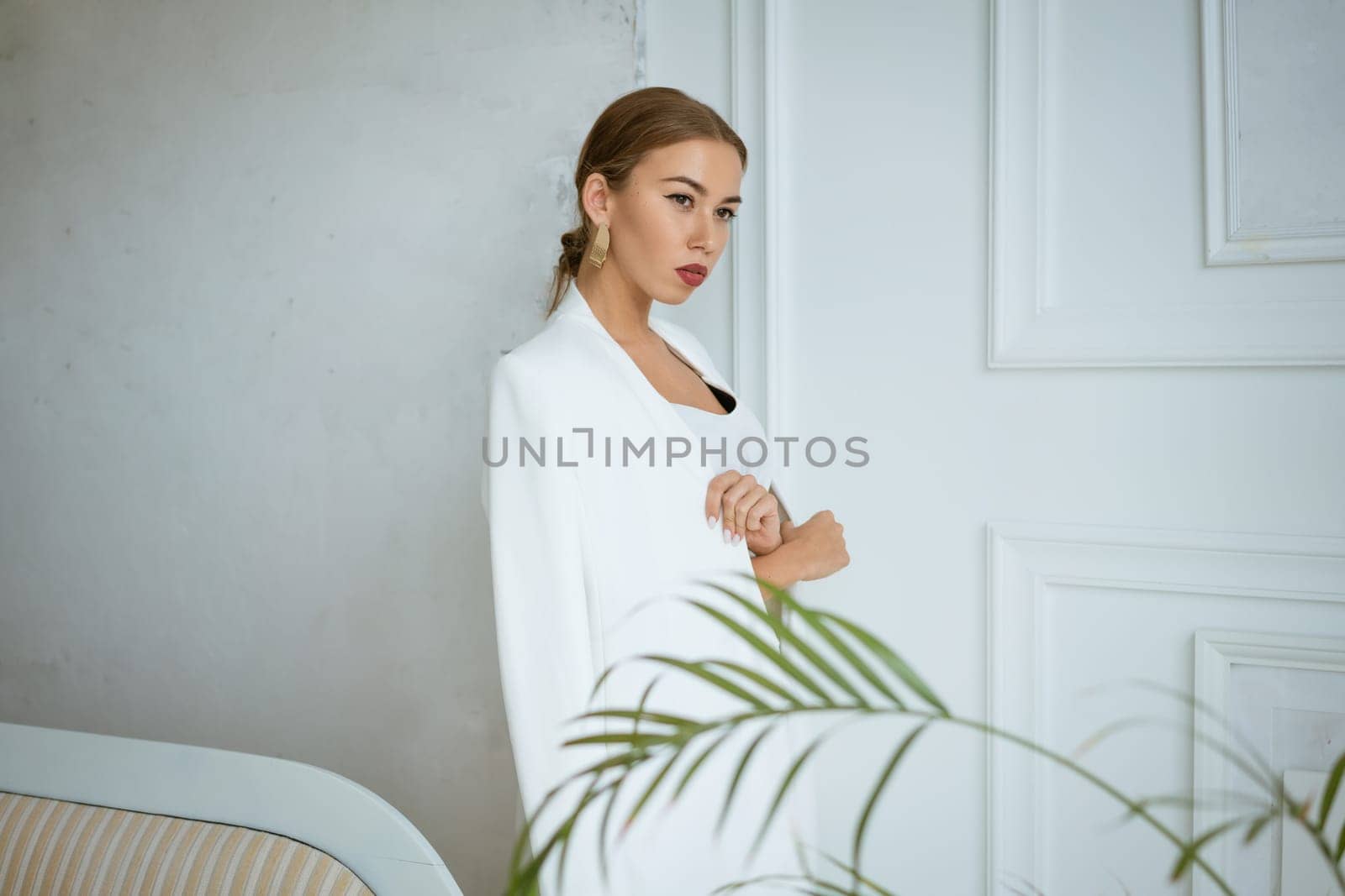 portrait of a young blonde woman in white clothes on the background of a white interior by EkaterinaPereslavtseva