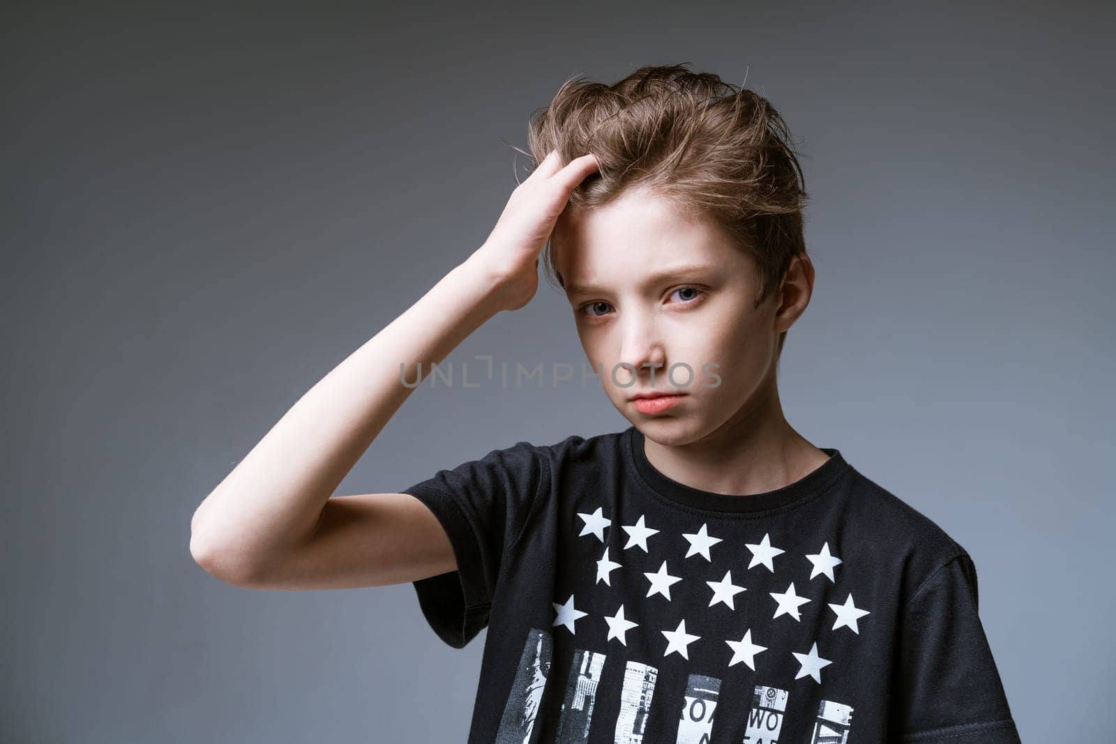 Boy posing on gray background in black t-shirt by EkaterinaPereslavtseva