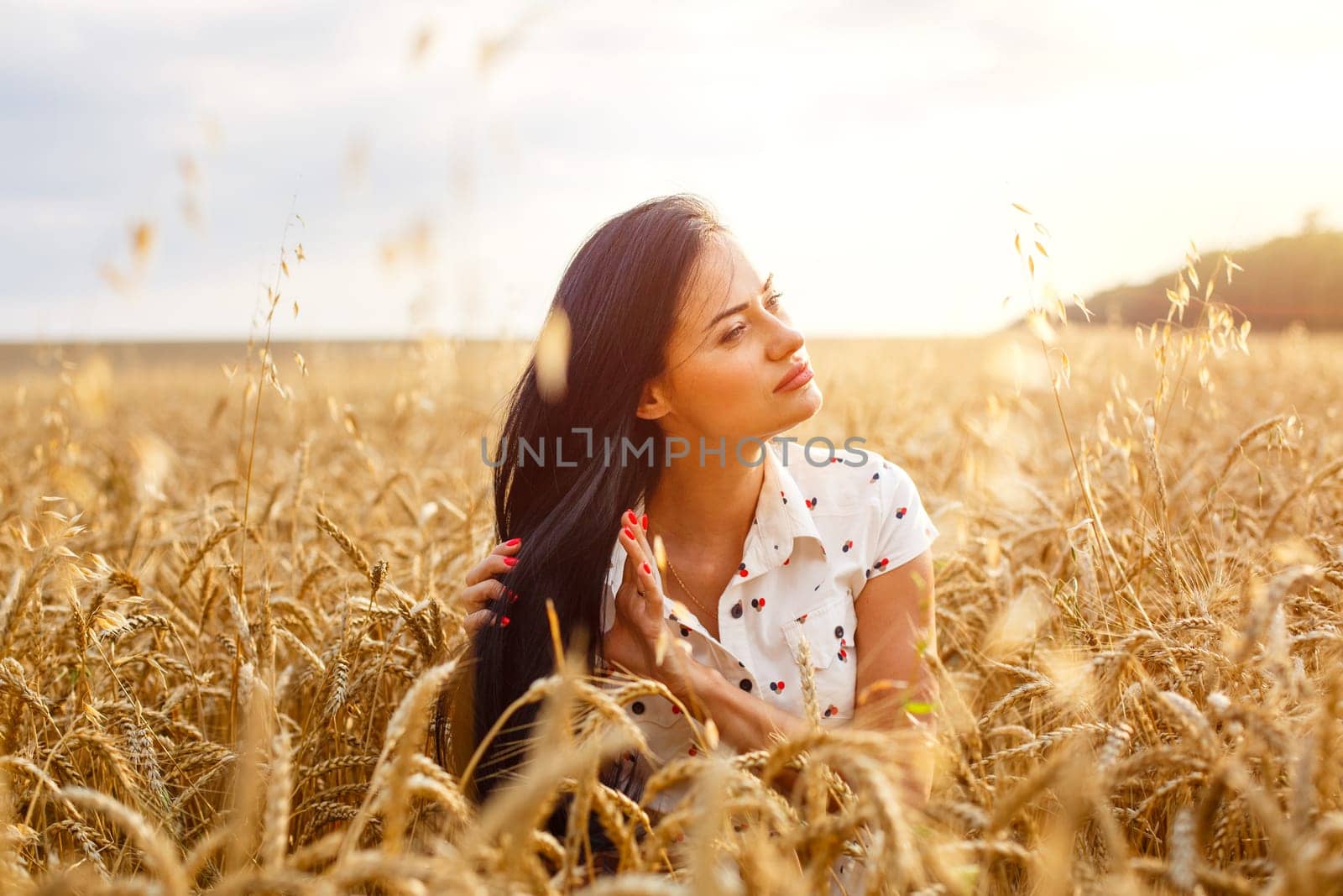 Beauty Girl Outdoors enjoying nature on wheat field. by EkaterinaPereslavtseva