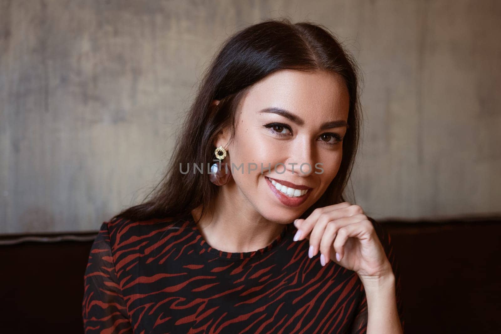 Female beautiful portrait of a brunette Caucasian nationality close-up, beautiful brown eyes with makeup in a young woman