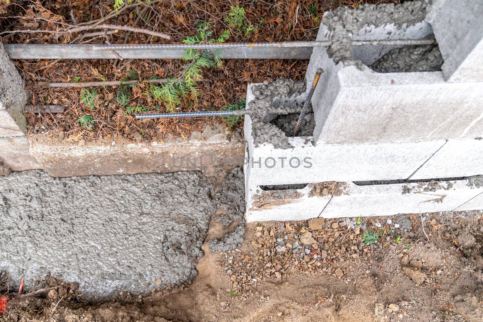 pour concrete from the mixer of the foundation of the building in the ground.