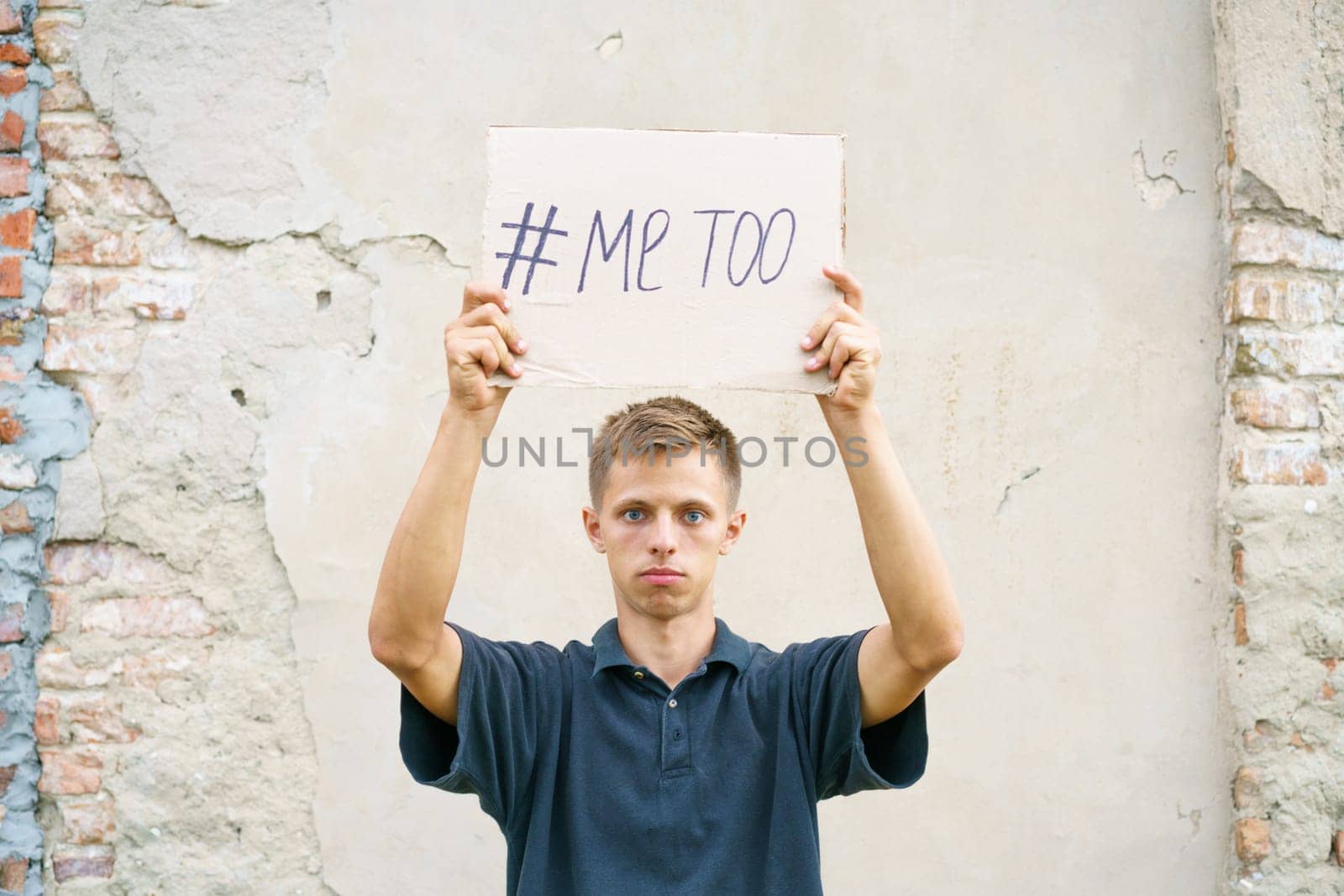 Men alone with depressed expression and showing a paper with a metoo text. Metoo as a new movement. Ideas to stop violence against , sexual harassment and rape, human trafficking