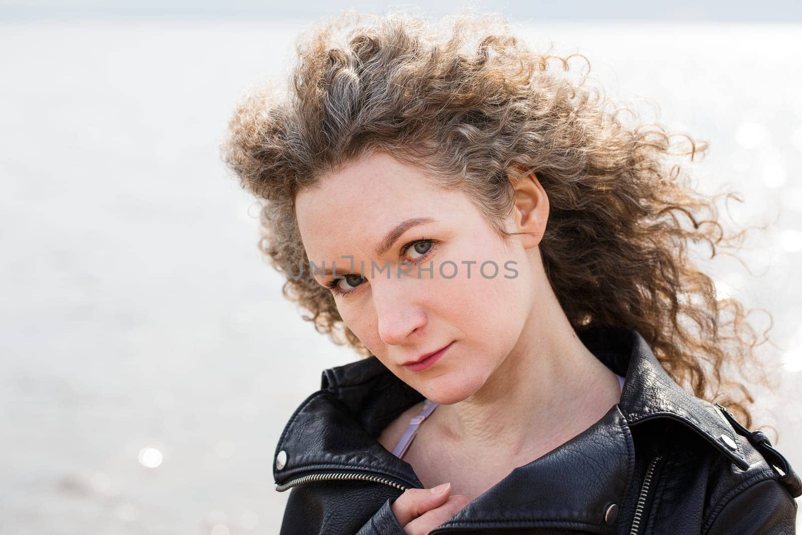 Portrait of a curly woman on the background of the bay by EkaterinaPereslavtseva