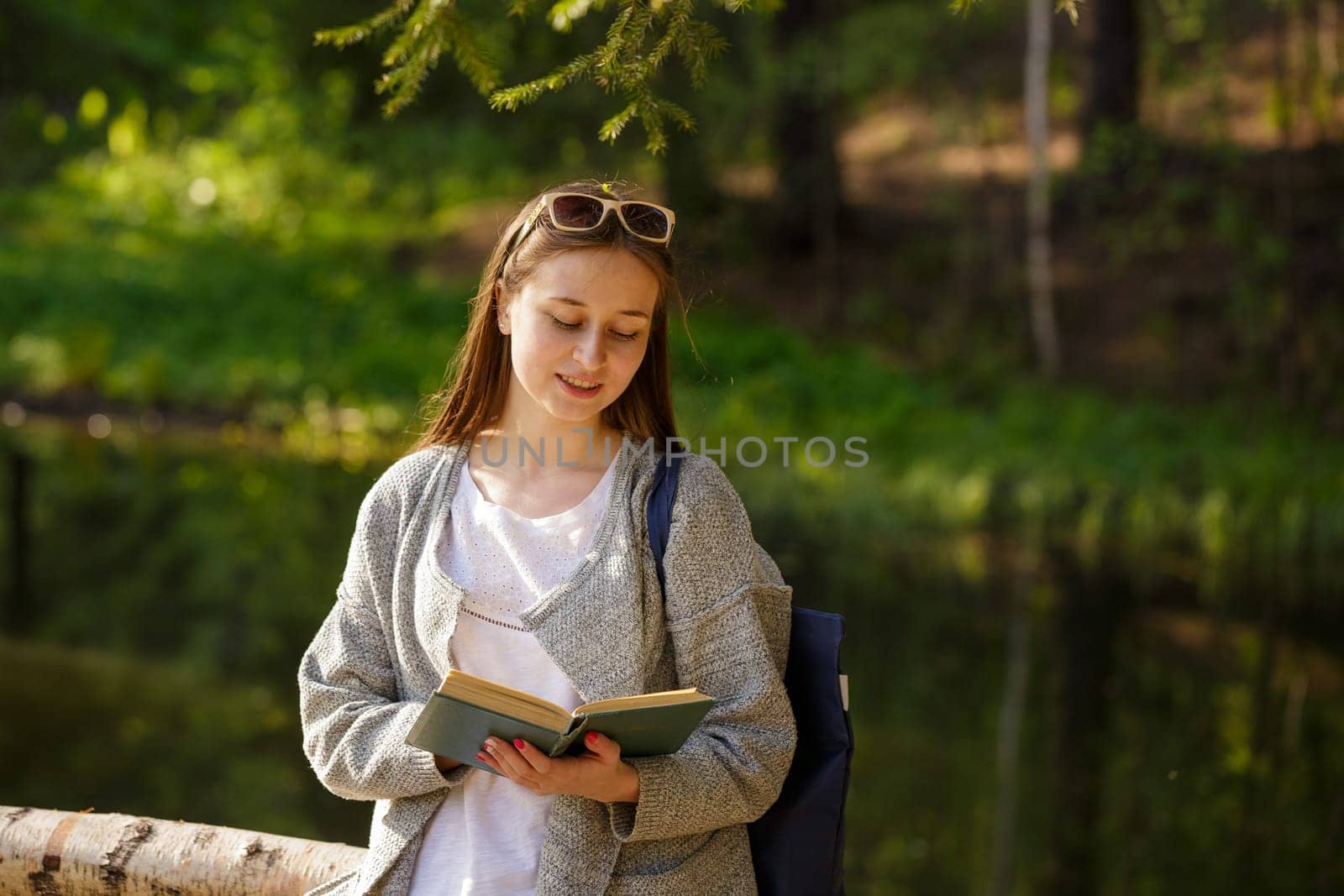 Cute girl in the park with a book in hand by EkaterinaPereslavtseva