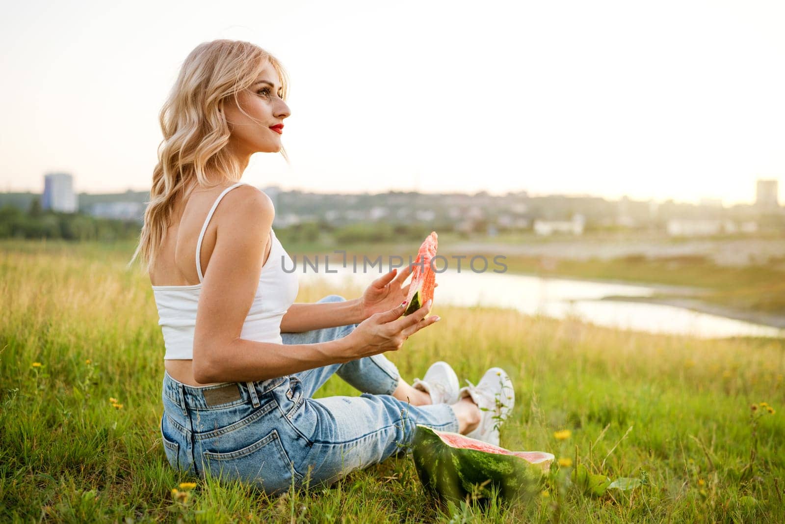 Portrait of a happy young woman enjoying and eating by EkaterinaPereslavtseva