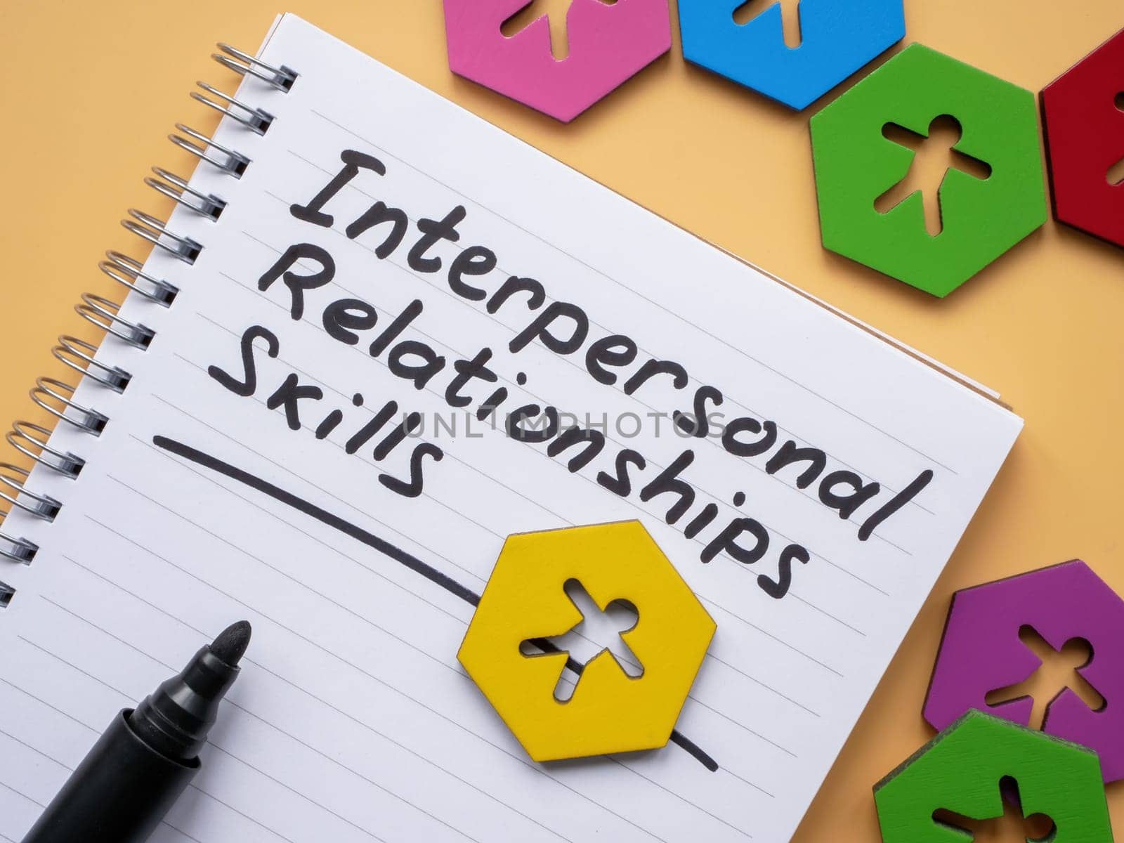 Page with inscription Interpersonal Relationships skills and figurines. by designer491