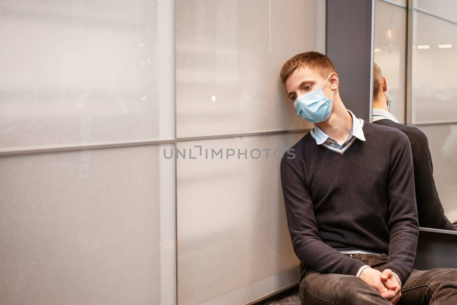 guy sitting in a protective mask sad by EkaterinaPereslavtseva