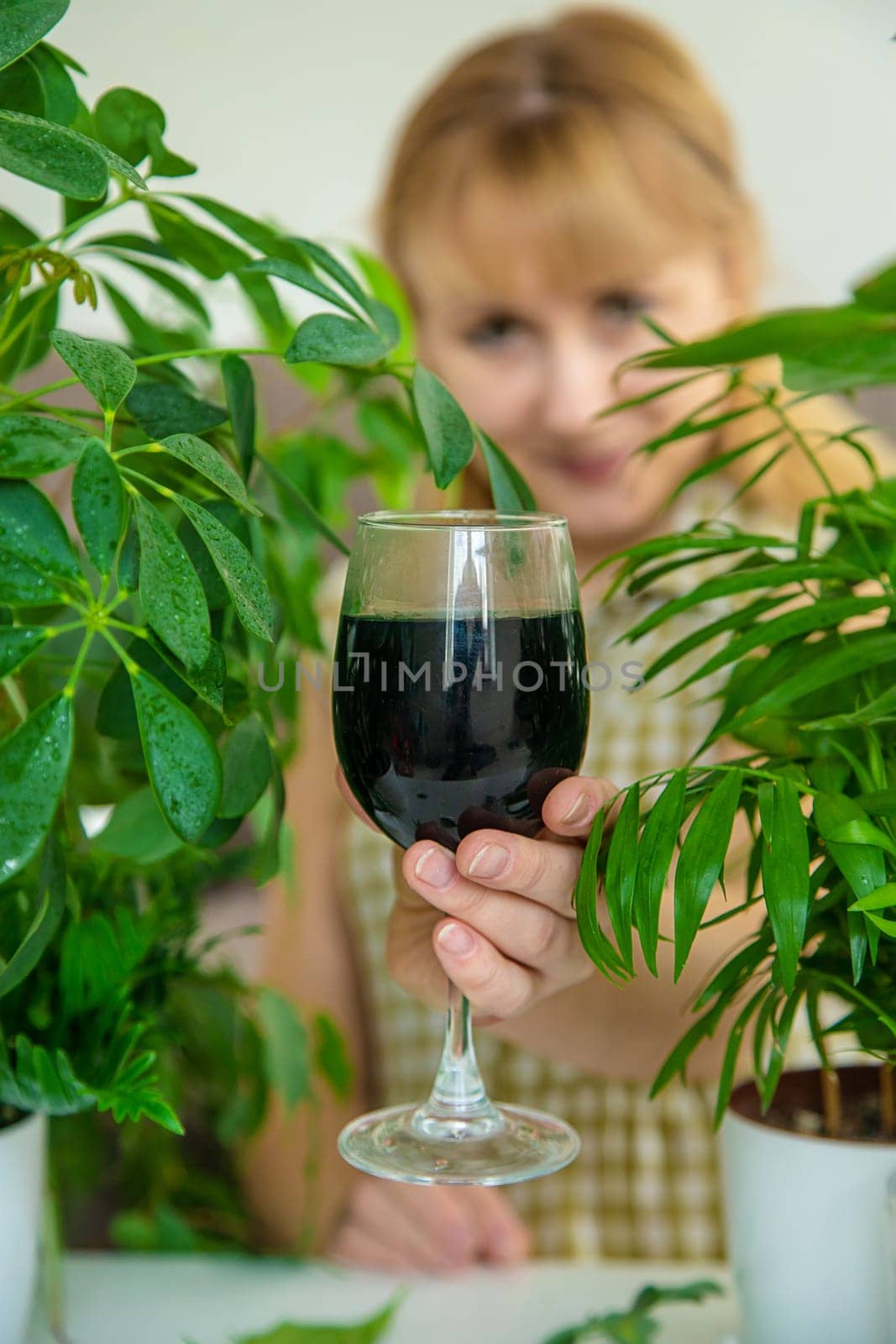 A woman drinks liquid chlorophyll. Selective focus. by yanadjana